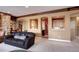 Inviting living room with a stone fireplace, built-in shelves, and golf simulator at 580 Summer Mist Cir, Castle Rock, CO 80104