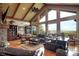 Spacious living room with hardwood floors, a stone fireplace, and floor to ceiling windows with a beautiful view at 580 Summer Mist Cir, Castle Rock, CO 80104