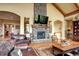 Comfortable living room boasts a stone fireplace and archways at 580 Summer Mist Cir, Castle Rock, CO 80104