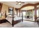 Bright main bedroom showcases four-poster bed, elevated sitting area, and expansive outdoor views at 580 Summer Mist Cir, Castle Rock, CO 80104