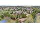 Aerial view of a brick home featuring a playground, volleyball court, and landscaped backyard at 286 Claymoor Ct, Castle Pines, CO 80108
