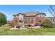 Backyard featuring a brick home, patio with furniture, and grassy area at 286 Claymoor Ct, Castle Pines, CO 80108