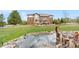 Large backyard featuring a pond, grassy area, and brick home at 286 Claymoor Ct, Castle Pines, CO 80108