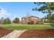 Enjoy the spacious backyard with a stone pathway, lush lawn, and inviting patio, ideal for outdoor living at 286 Claymoor Ct, Castle Pines, CO 80108