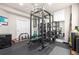 A home gym featuring weights, a weight rack, mirrors, and hardwood flooring at 286 Claymoor Ct, Castle Pines, CO 80108