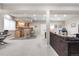 Open basement featuring a wet bar with seating, neutral walls, and carpeted flooring at 286 Claymoor Ct, Castle Pines, CO 80108