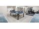 Finished basement with a ping pong table, treadmill, and neutral colored walls at 286 Claymoor Ct, Castle Pines, CO 80108
