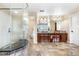 Bright bathroom features large glass-enclosed shower, dual vanities with granite counters, and a full vanity at 286 Claymoor Ct, Castle Pines, CO 80108