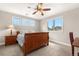Bedroom featuring a wood sleigh bed, large windows, an adjacent study area, and neutral walls at 286 Claymoor Ct, Castle Pines, CO 80108