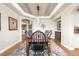 Dining room features a long wooden table, elegant chandelier, and decorative accents at 286 Claymoor Ct, Castle Pines, CO 80108