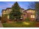 Inviting two-story brick home featuring a lush front lawn and mature landscaping at 286 Claymoor Ct, Castle Pines, CO 80108