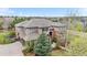 A stately home featuring a brick and stucco exterior, complemented by a well-manicured lawn and mature trees at 286 Claymoor Ct, Castle Pines, CO 80108