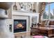 Living room fireplace with decorative mantel and tile surround, next to leather sofa and decorative accents at 286 Claymoor Ct, Castle Pines, CO 80108
