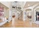Grand foyer with hardwood floors, elegant staircase, and ample natural light at 286 Claymoor Ct, Castle Pines, CO 80108