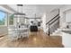 Bright kitchen features white cabinets, a dark island, hardwood floors, and a casual dining area at 286 Claymoor Ct, Castle Pines, CO 80108