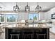 Bright kitchen with white cabinets, granite island, and scenic window views at 286 Claymoor Ct, Castle Pines, CO 80108