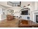 Bright living room with hardwood floors, a fireplace, and large built-in entertainment center at 286 Claymoor Ct, Castle Pines, CO 80108