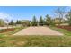 An outdoor volleyball court in a backyard featuring well manicured grass and mature trees at 286 Claymoor Ct, Castle Pines, CO 80108