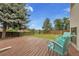 Expansive back deck providing ample space for outdoor gatherings, complemented by lush greenery and sunny skies at 12671 W Dakota Dr, Lakewood, CO 80228