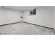 Spacious basement featuring neutral carpet and a bright window, perfect for customization and comfort at 12671 W Dakota Dr, Lakewood, CO 80228