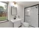 Bathroom features a modern black framed shower, single sink vanity and updated fixtures at 12671 W Dakota Dr, Lakewood, CO 80228