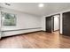 Bright bedroom featuring hardwood floors, large window and double closet at 12671 W Dakota Dr, Lakewood, CO 80228