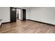 Spacious bedroom with wood flooring and dark trim with entry door and double closet at 12671 W Dakota Dr, Lakewood, CO 80228