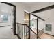 An upstairs foyer boasts hardwood floors, beam accents, iron railings, and a decorative chandelier at 12671 W Dakota Dr, Lakewood, CO 80228
