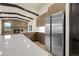 Spacious kitchen with stone accent wall, stainless steel fridge, modern cabinets, and island at 12671 W Dakota Dr, Lakewood, CO 80228