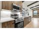 Modern kitchen features stainless appliances, wood cabinets, white countertops, and tiled backsplash at 12671 W Dakota Dr, Lakewood, CO 80228