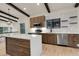 Bright, open kitchen with stainless appliances, light wood cabinets, island, and dark exposed beams at 12671 W Dakota Dr, Lakewood, CO 80228