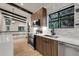 Modern kitchen features stainless appliances, wood cabinets, white countertops, and tiled backsplash at 12671 W Dakota Dr, Lakewood, CO 80228
