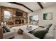 Staged living room with stone fireplace, cozy seating, and an inviting atmosphere for relaxing and entertaining at 12671 W Dakota Dr, Lakewood, CO 80228