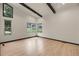 Bright, spacious living room with hardwood floors and black ceiling beams, well lit with lots of natural light at 12671 W Dakota Dr, Lakewood, CO 80228