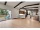 Open living space with an open floor plan and dark exposed beams connects to backyard deck at 12671 W Dakota Dr, Lakewood, CO 80228