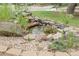 Charming rock garden with small decorative fish pond with stacked rocks at 12671 W Dakota Dr, Lakewood, CO 80228