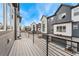 Balcony with metal railings overlooks modern townhomes and private garages with a blue sky overhead at 5165 Vivian St, Wheat Ridge, CO 80033