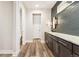 Modern bathroom with a long vanity, stylish mirror and lighting, and beautiful tile backsplash at 5165 Vivian St, Wheat Ridge, CO 80033