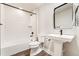 Bathroom featuring a shower/tub combo, pedestal sink, and a modern mirror at 5165 Vivian St, Wheat Ridge, CO 80033