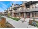 Charming multi-story townhomes feature brick and modern gray siding, plus small front lawns for a suburban feel at 5165 Vivian St, Wheat Ridge, CO 80033