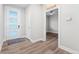 Bright foyer boasts a modern door with frosted glass and views to other rooms at 5165 Vivian St, Wheat Ridge, CO 80033