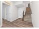 Hallway features hardwood floors, stairs, and access to a large storage closet at 5165 Vivian St, Wheat Ridge, CO 80033