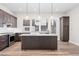 Kitchen featuring stainless steel appliances, modern lighting, and an island with stone countertop at 5165 Vivian St, Wheat Ridge, CO 80033