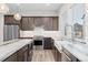 Modern kitchen featuring stainless steel appliances, a farmhouse sink, and sleek countertops at 5165 Vivian St, Wheat Ridge, CO 80033