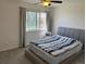 Bright bedroom featuring a ceiling fan, carpet and a large window with curtains at 8657 Clay St # 383, Westminster, CO 80031