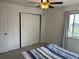 Bright bedroom featuring a ceiling fan, closet doors and a window with curtains at 8657 Clay St # 383, Westminster, CO 80031