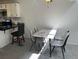 Dining area with a modern table set near a kitchen, complemented by neutral paint at 8657 Clay St # 383, Westminster, CO 80031
