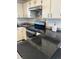 A kitchen featuring white cabinetry, stone countertops, and stainless steel appliances at 8657 Clay St # 383, Westminster, CO 80031