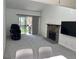 Bright living room with a stone fireplace, a sliding door to a balcony, and neutral gray carpet at 8657 Clay St # 383, Westminster, CO 80031