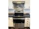 Close-up of stainless steel oven with white cabinets and a tile backsplash at 8657 Clay St # 383, Westminster, CO 80031